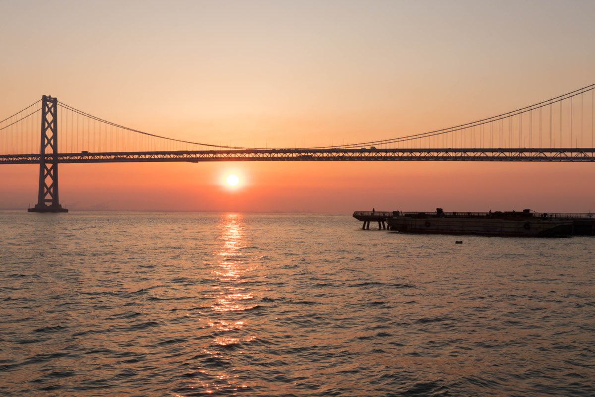 Wildfire smoke turning the sky orange over the San Francisco Bay Bridge